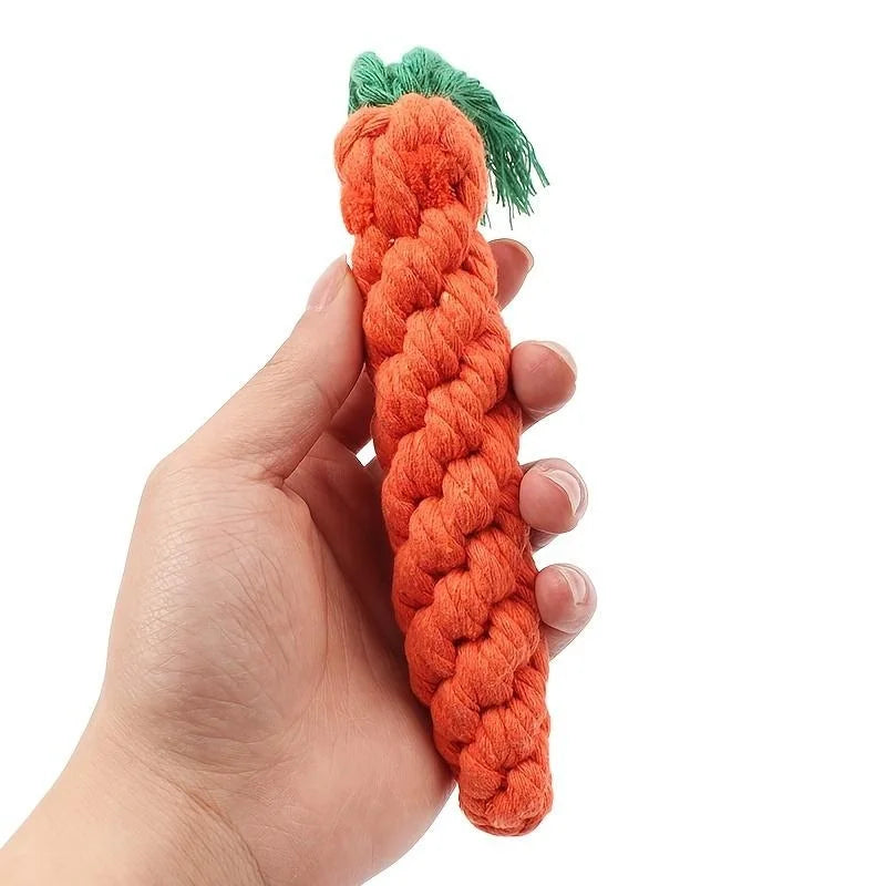 Carrot-shaped cotton rope dog chew toy held in hand, showing size, texture, and safe material for medium and teething dogs.