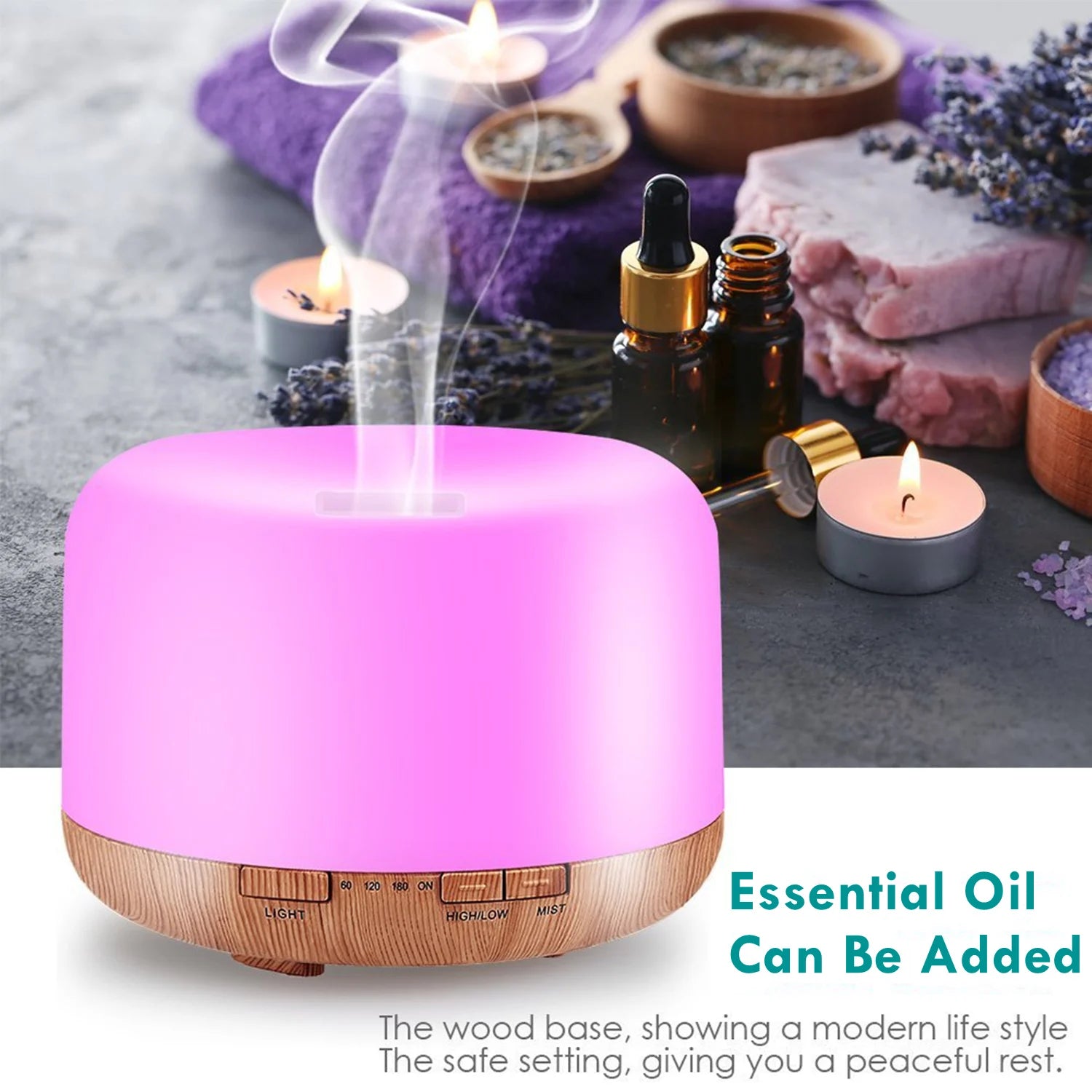 Pink essential oil diffuser with wooden base on a gray surface with candles and lavender.