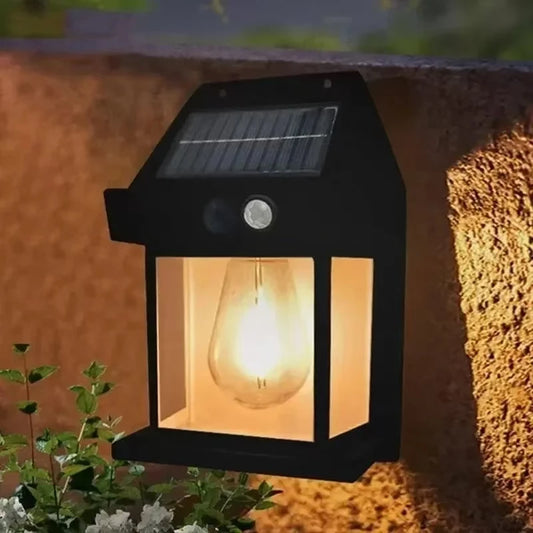 Solar-powered outdoor light fixture on a wall with a warm glow